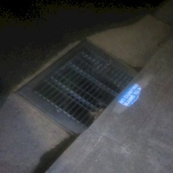Storm Drain With a Small Amount of Water in Richmond at Night (Cellphone Field)